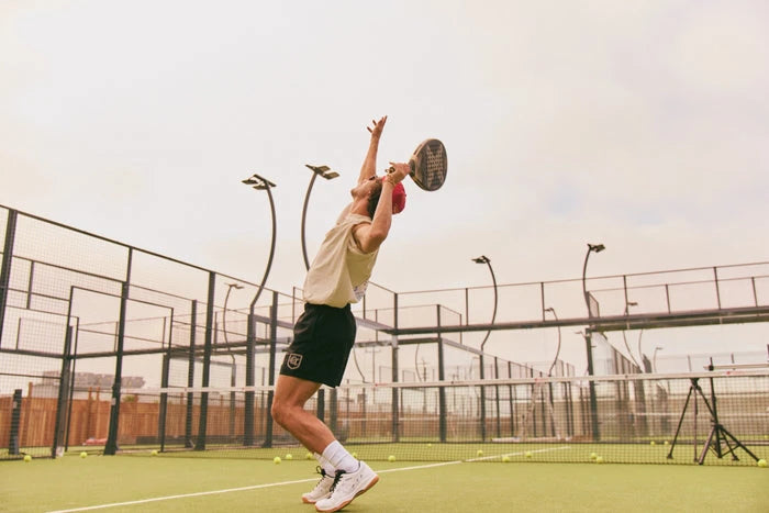 A Courts Club player reaching for a padel shot